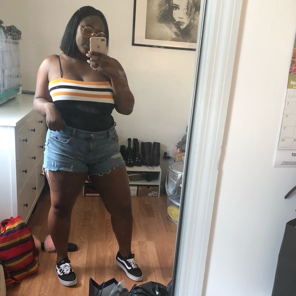 Black bodysuit w/ black, yellow, and white strips